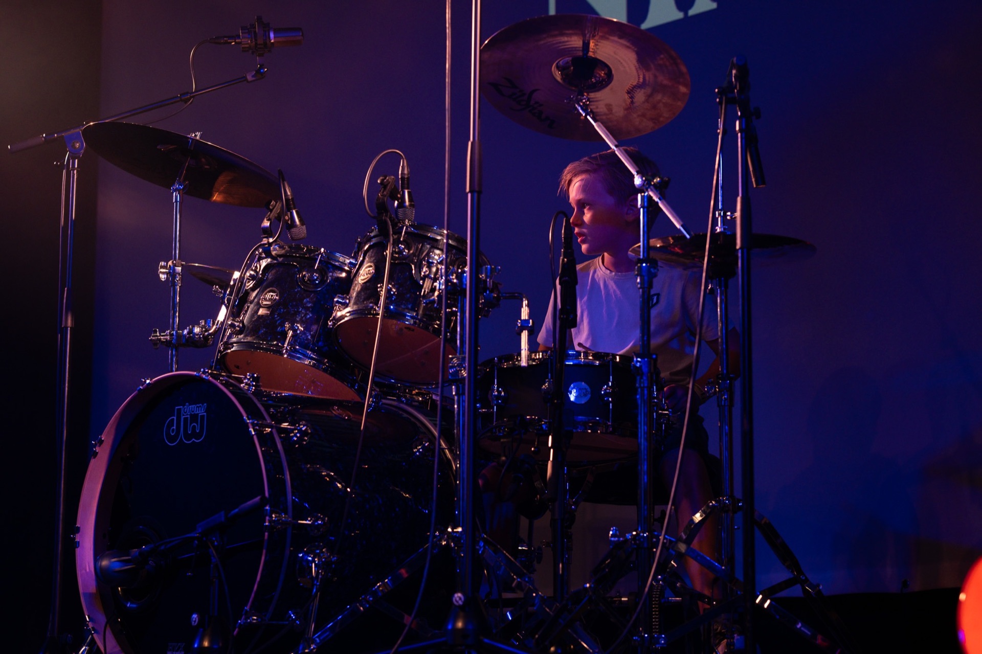 Drummer achter het drumstel in paars stagelicht bij MusicSoulHouse